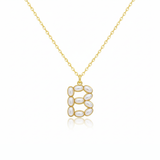 Gold necklace with a pendant shaped B on a white background