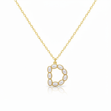 Gold necklaces with pearl-like beads on a initial pendant D with white background