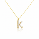 Gold necklaces with pearl beads on a initial pendant H with white background