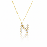 Gold necklaces with pearl beads on a initial pendant N with white background
