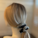 Elegant satin hair scrunchie embellished with delicate pearls and beads—adding a touch of sophistication and shine to any hairstyle.