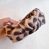 Fashion-forward headband featuring a classic leopard print on a sleek, structured band—offering a perfectly chic accent for everyday or statement styling.