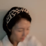 Fashion-forward headband featuring a classic leopard print on a sleek, structured band—offering a perfectly chic accent for everyday or statement styling.