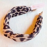Fashion-forward headband featuring a classic leopard print on a sleek, structured band—offering a perfectly chic accent for everyday or statement styling.