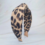 Fashion-forward headband featuring a classic leopard print on a sleek, structured band—offering a perfectly chic accent for everyday or statement styling.