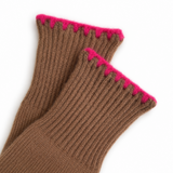 A close-up of a pair of brown ribbed knit socks with a bright pink zigzag trim along the top cuff, set against a plain white background.