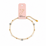 Delicate gold anklet featuring small clover-shaped charms with evenly spaced bead stations along a fine chain for a minimal, layered look.