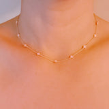 Gold-toned necklace featuring a delicate colored clover pendant, suspended on a fine chain for a soft pop of charm and color.