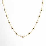 Gold-toned necklace featuring a delicate colored clover pendant, suspended on a fine chain for a soft pop of charm and color.