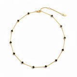 Gold-toned necklace featuring a delicate colored clover pendant, suspended on a fine chain for a soft pop of charm and color.