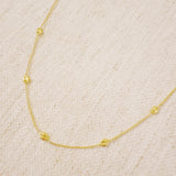 Delicate gold-tone necklace featuring evenly spaced petite chain links for a minimal and elegant look.