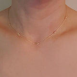 Delicate gold-tone necklace featuring evenly spaced petite chain links for a minimal and elegant look.