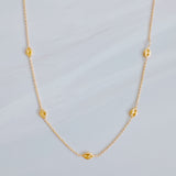 Delicate gold-tone necklace featuring evenly spaced petite chain links for a minimal and elegant look.