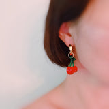 Playful cherry-themed earrings featuring vibrant red cherry charms with green stems, adding a fun and fruity touch to any outfit.