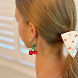 Playful cherry-themed earrings featuring vibrant red cherry charms with green stems, adding a fun and fruity touch to any outfit.