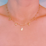 Gold chain necklace featuring playful pickleball-themed charms including a pickleball paddle, a ball, a star, and a colorful striped square accent, perfect for fans of the sport.