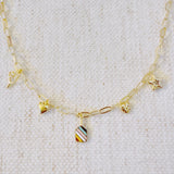 Gold chain necklace featuring playful pickleball-themed charms including a pickleball paddle, a ball, a star, and a colorful striped square accent, perfect for fans of the sport.