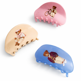 Three hair clips with bear illustrations on a white background
