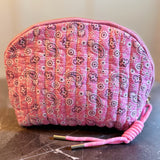Quilted cosmetic case featuring a colorful paisley pattern and zip closure, combining stylish design with soft, padded texture for everyday beauty storage.