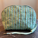 Quilted cosmetic case featuring a colorful paisley pattern and zip closure, combining stylish design with soft, padded texture for everyday beauty storage.