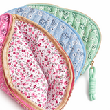 Set of three fabric pouches with floral patterns on a white background