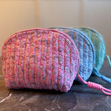 Quilted cosmetic case featuring a colorful paisley pattern and zip closure, combining stylish design with soft, padded texture for everyday beauty storage.