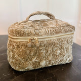 Quilted velvet vanity bag with top handle and zipper closure, available in creamy velvet and vintage moss color variants