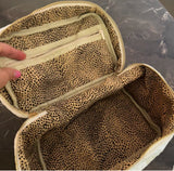 Quilted velvet vanity bag with top handle and zipper closure, available in creamy velvet and vintage moss color variants