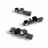 Three black and silver hair clips on a white background