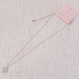 Silver cross pendant necklace featuring a symmetrical arrangement of radiant-cut cubic zirconia stones, creating a brilliant and elegant sparkle on a fine silver chain.