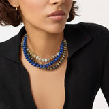 A collection of polished gemstone bead necklaces in various colors, including deep blue, green, brown, pink, and cream. Each necklace features smooth, rounded beads with a glossy finish, offering a timeless and versatile accessory look.