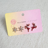 Set of mini stud earrings featuring snowflake and reindeer charms – dainty and winter-themed