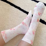 Soft and stylish socks adorned with delicate watercolor-inspired florals, offering a dreamy and romantic touch to everyday wear.