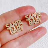 Festive stud earrings with gold-tone holiday charm and subtle sparkle – chic Santa baby style