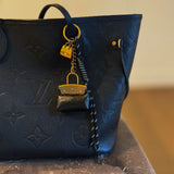 Glamorous bag charm featuring a mini purse design with gold-tone accents and playful details—perfect for adding a touch of sass and luxe to any handbag or tote.