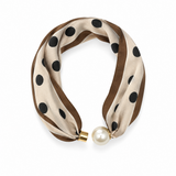 A double-strand silk scarf with a brown and beige base, decorated with black polka dots, finished with a gold metal clasp and a white faux-pearl bead.