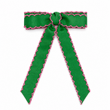 Green ribbon with pink trim on a white background