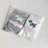 Crew-length socks featuring a charming Scottie dog pattern, designed in two coordinated colorways. The Scottie silhouettes are playfully on each sock, creating a fun and cozy look perfect for dog lovers and everyday wear.