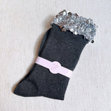 Sparkly socks featuring a sequin-embellished top band, adding a touch of chic shine and glam to any outfit.