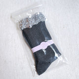 Sparkly socks featuring a sequin-embellished top band, adding a touch of chic shine and glam to any outfit.