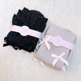 Set of two shimmer socks featuring delicate bow embellishments, designed in a chic, sparkly finish for a stylish and feminine touch.
