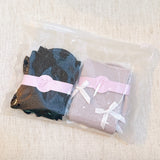 Set of two shimmer socks featuring delicate bow embellishments, designed in a chic, sparkly finish for a stylish and feminine touch.
