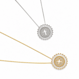 Two necklaces with circular pendants featuring crosses on a white background