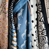 Elegant satin square scarf with a smooth, glossy finish—perfect for versatile styling as a hair accessory, neck tie, or bag accent.