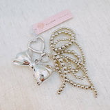 Shiny silver bow charm and cascading bead tassels – glam and elegant
