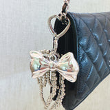 Shiny silver bow charm and cascading bead tassels – glam and elegant