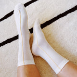 Set of two minimalist crew socks featuring subtle contrast stitching at the top and toe, adding a clean and stylish detail to everyday wear.