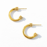 Gold hoop earrings on a white background