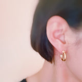 Minimalist gold-tone hoop earrings with a smooth, polished finish and classic round shape, perfect for everyday wear.