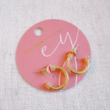 Minimalist gold-tone hoop earrings with a smooth, polished finish and classic round shape, perfect for everyday wear.